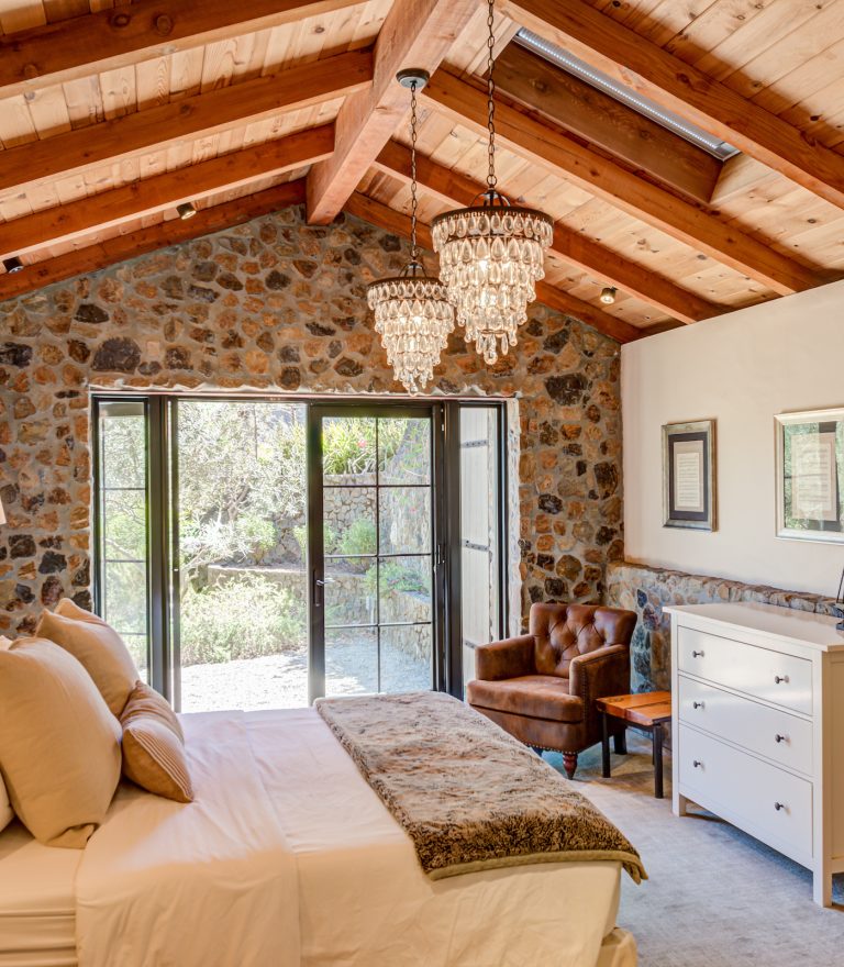 Bedroom remodel with wood beam ceiling and chandeliers by Sonoma County Home Builder LEFF Design Build.